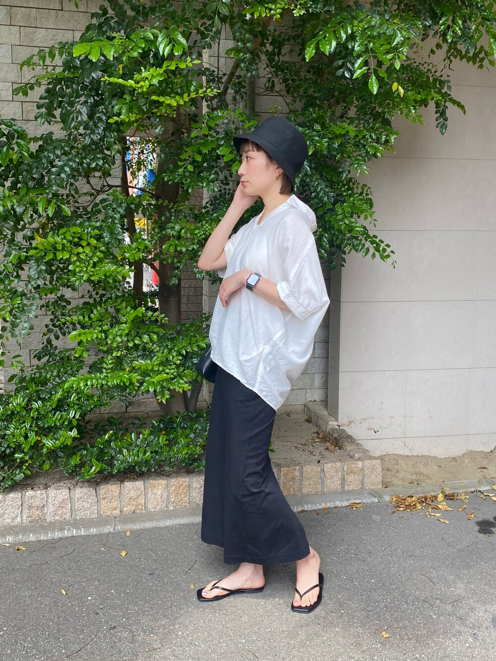 ホワイト系のシャツ/ブラウス、ブラック系のスカートを着用したレディースの春コーディネートの2枚目の写真