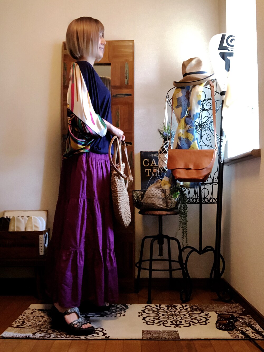 ベージュ系のかごバッグ、ピンク系のスカート、ブラック系のサンダルを着用したレディースの夏コーディネートの3枚目の写真