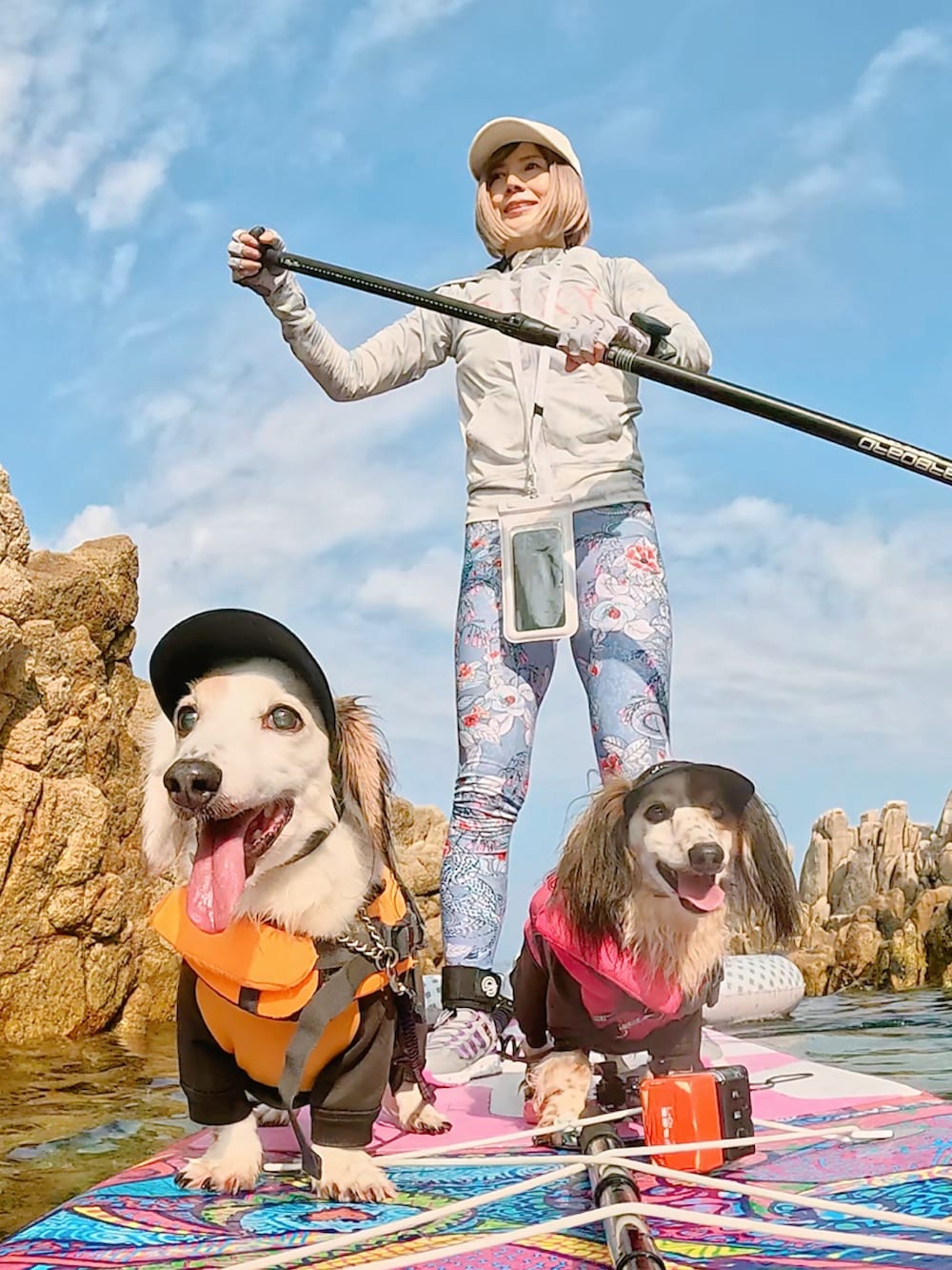 ホワイト系のキャップ、ブルー系のラッシュガード、ブルー系のレギンス/スパッツを着用したレディースの夏コーディネートの2枚目の写真