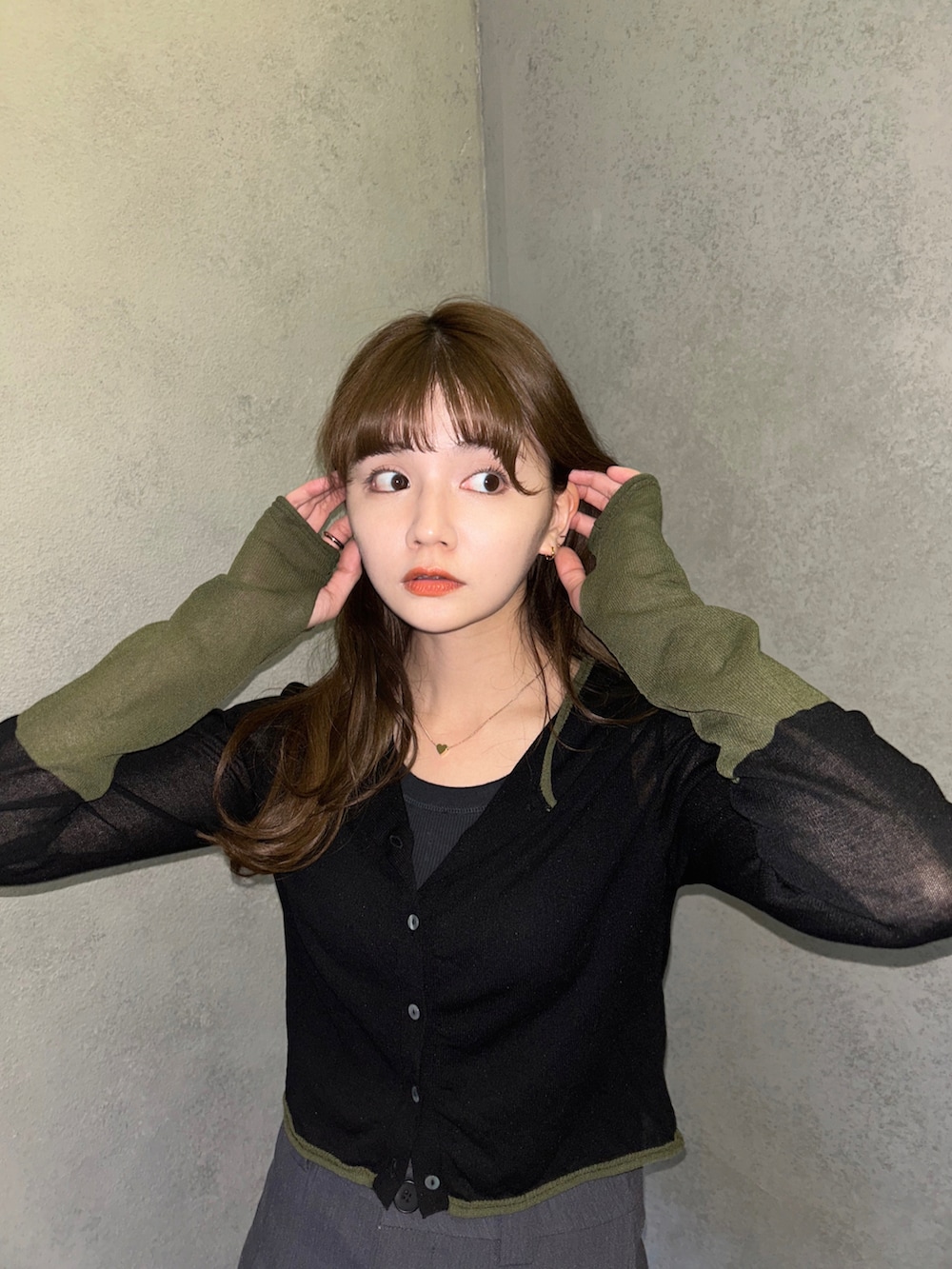 ブラック系のカーディガン/ボレロ、ブラック系のローファー、グレー系のスカートを着用したレディースの春コーディネートの2枚目の写真