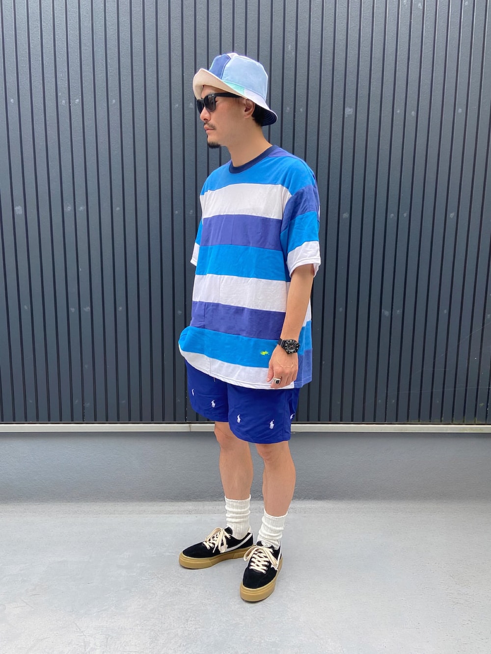 その他のTシャツ/カットソー、ブラック系のスニーカー、その他のハットを着用したメンズの夏コーディネートの3枚目の写真