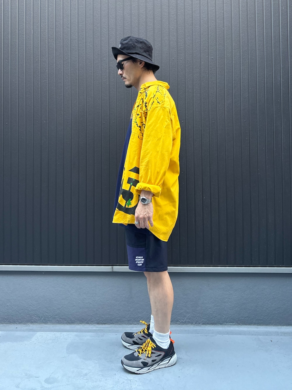 イエロー系のシャツ/ブラウス、ブルー系のTシャツ/カットソー、ブルー系のパンツを着用したメンズの秋コーディネートの2枚目の写真