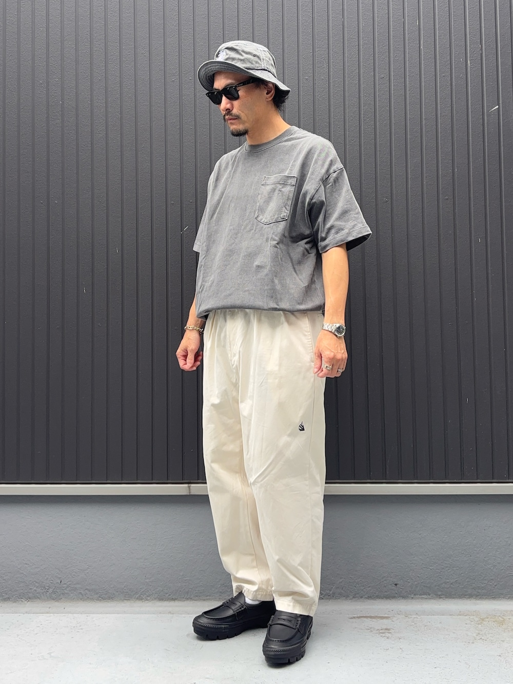ホワイト系のその他パンツ、ブラック系のTシャツ/カットソー、ブラック系のローファーを着用したメンズの秋コーディネートの3枚目の写真
