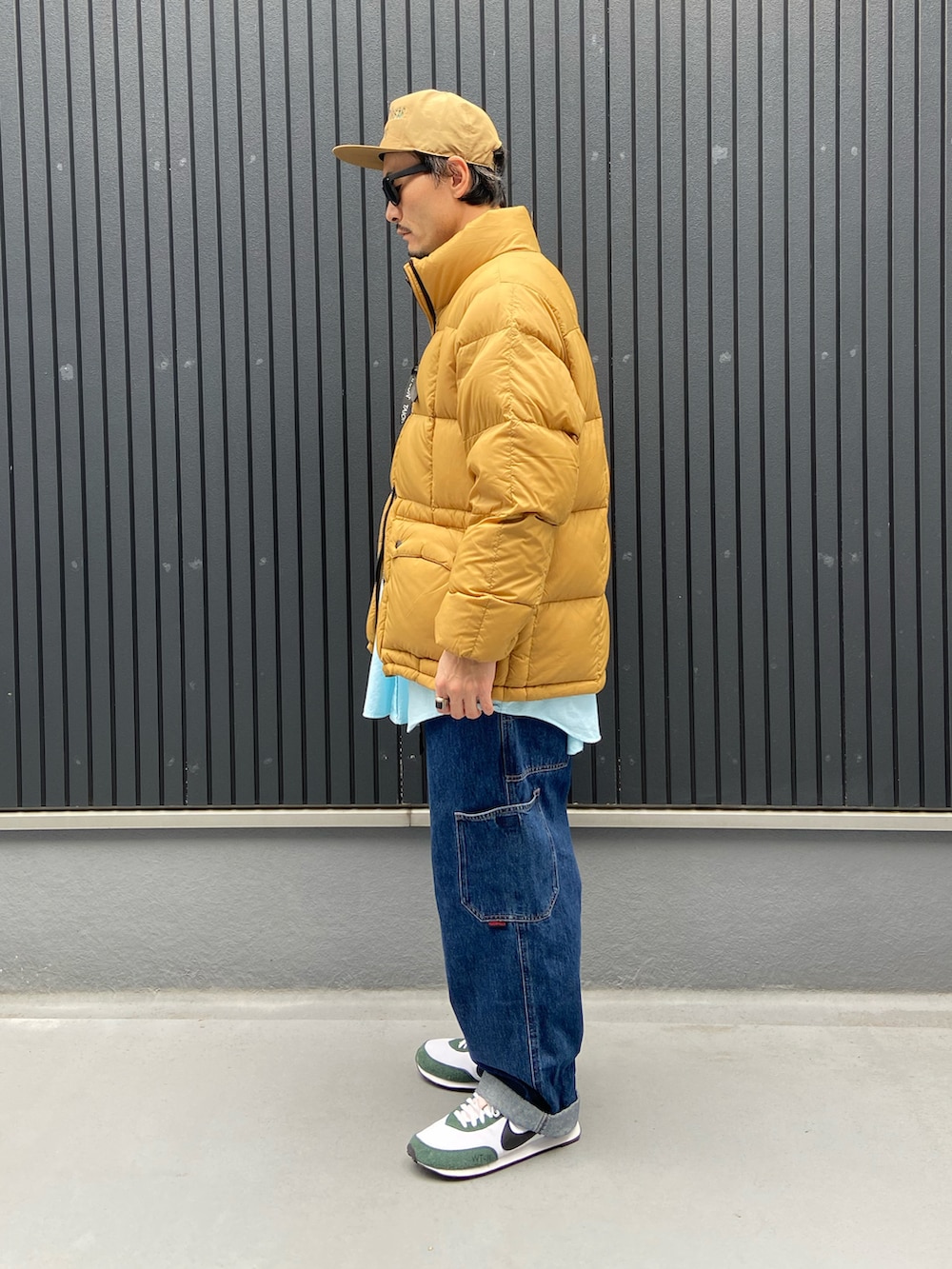 ベージュ系のダウンジャケット/コート、グリーン系のシャツ/ブラウス、ブルー系のデニムパンツを着用したメンズの冬コーディネートの2枚目の写真