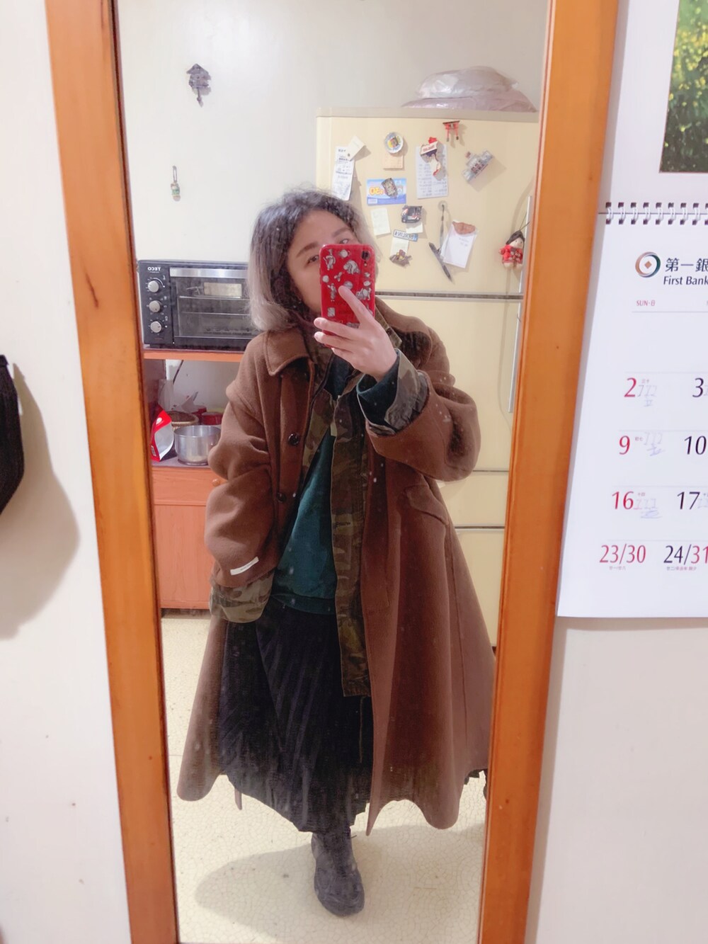 グリーン系のスウェット、グリーン系のミリタリージャケット、ブラック系のスニーカーを着用したレディースの冬コーディネートの2枚目の写真