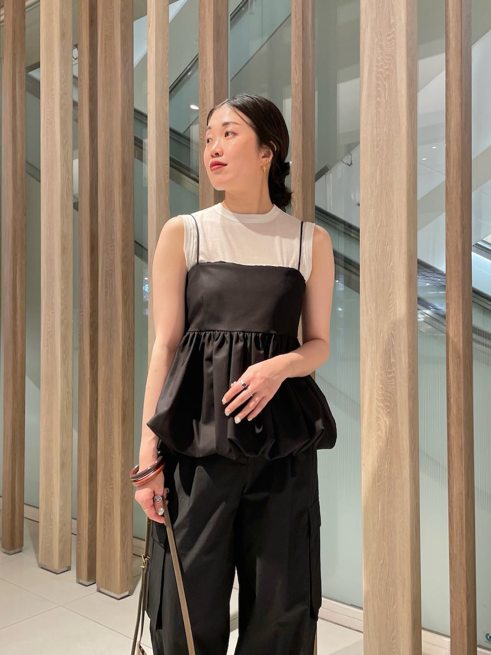 ブラック系のシャツ/ブラウス、ホワイト系のTシャツ/カットソー、ブラック系のカーゴパンツを着用したレディースの春コーディネートの3枚目の写真