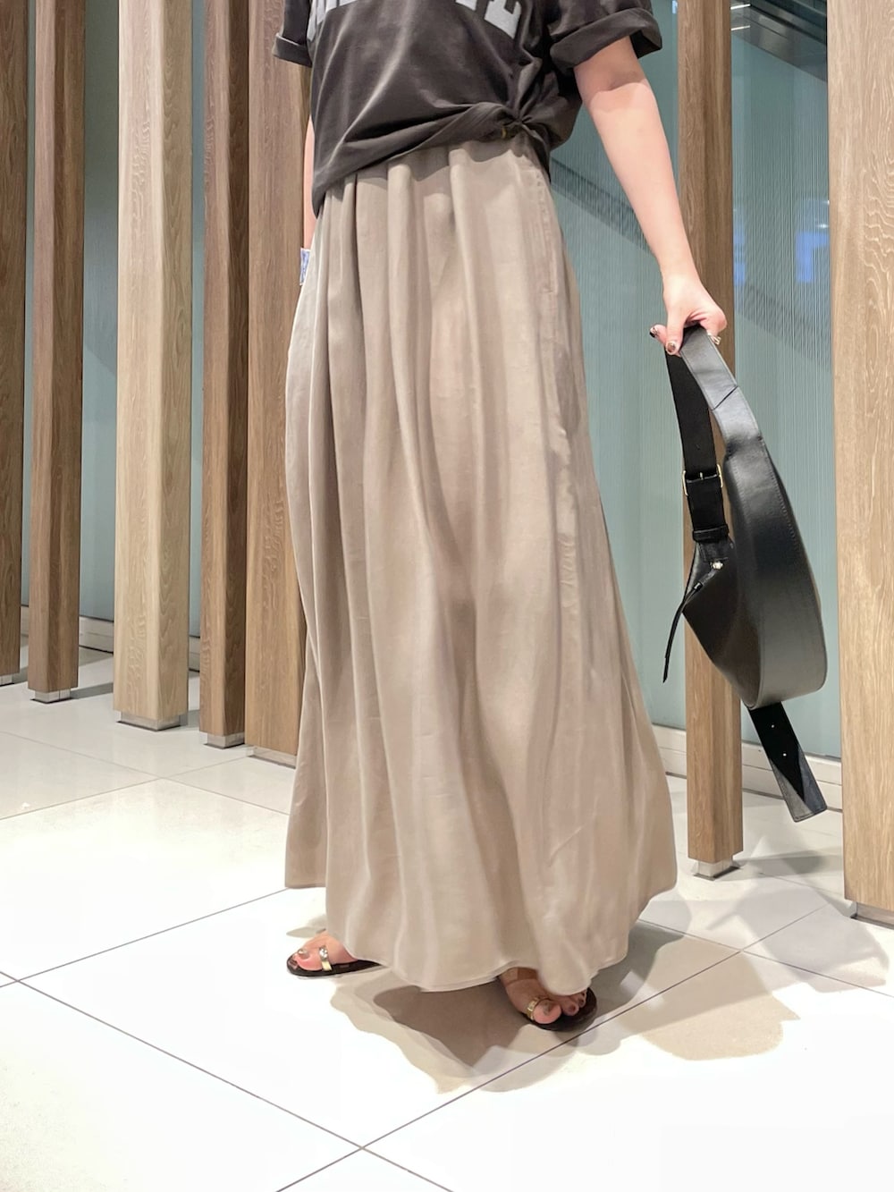 グレー系のTシャツ/カットソー、ベージュ系のワンピース、ブラウン系のサンダルを着用したレディースの夏コーディネートの5枚目の写真