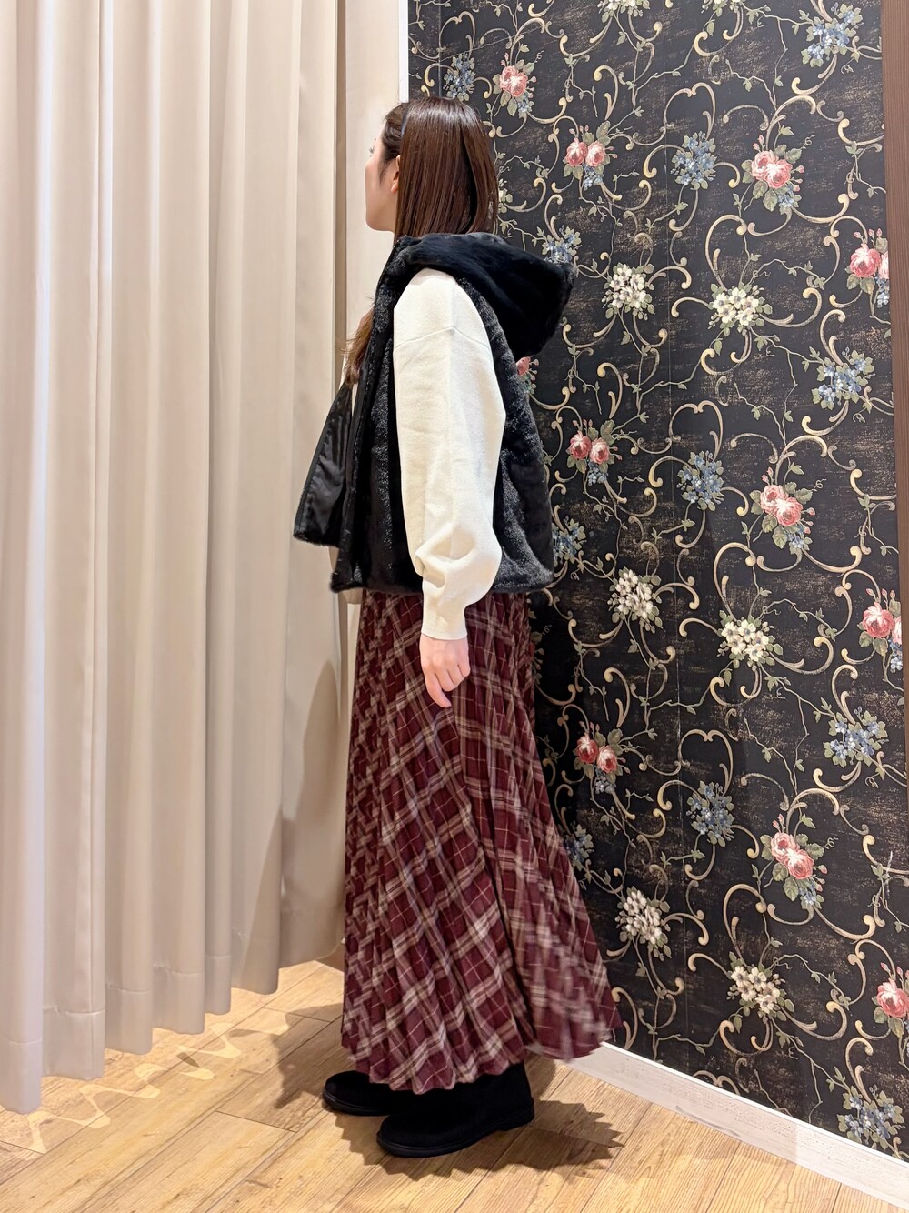 ブラック系のブルゾン、ホワイト系のニット/セーター、ブラック系のブーツを着用したレディースの秋コーディネートの4枚目の写真