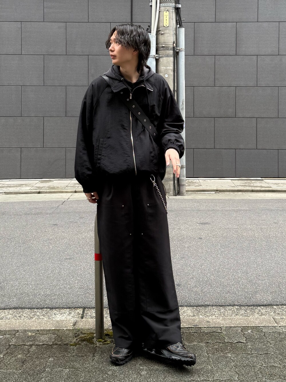 ブラック系のその他パンツ、ブラック系のトートバッグ、ブラック系のパーカーを着用したメンズの春コーディネートの3枚目の写真