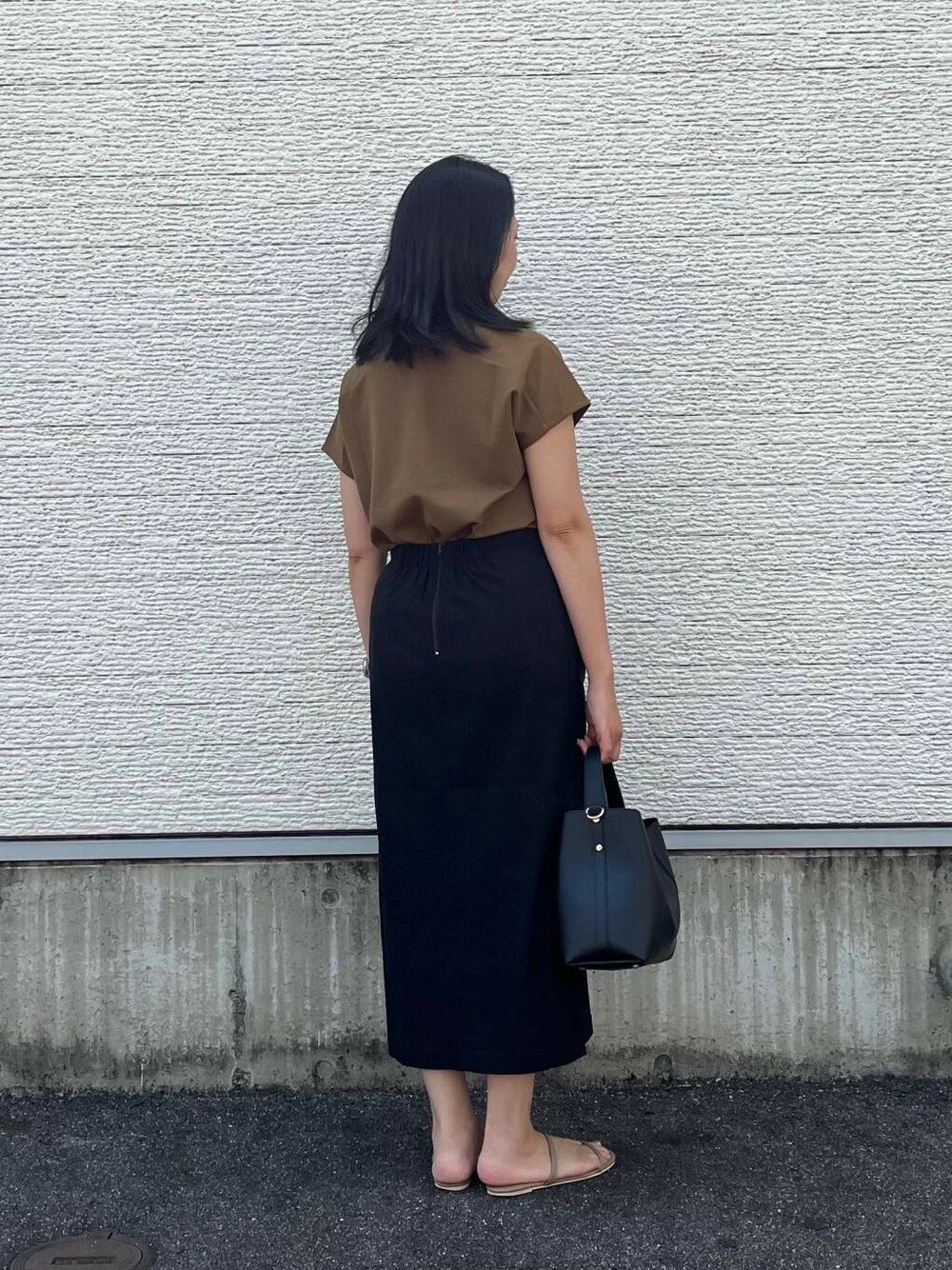ブラウン系のTシャツ/カットソー、ブラック系のトートバッグ、ブラック系のスカートを着用したレディースの夏コーディネートの5枚目の写真