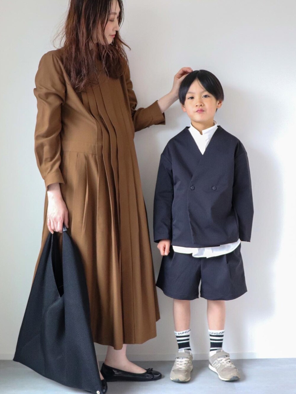 ブラック系のその他アウター、ホワイト系のシャツ/ブラウス、ブラック系のパンツを着用したキッズの春コーディネートの3枚目の写真