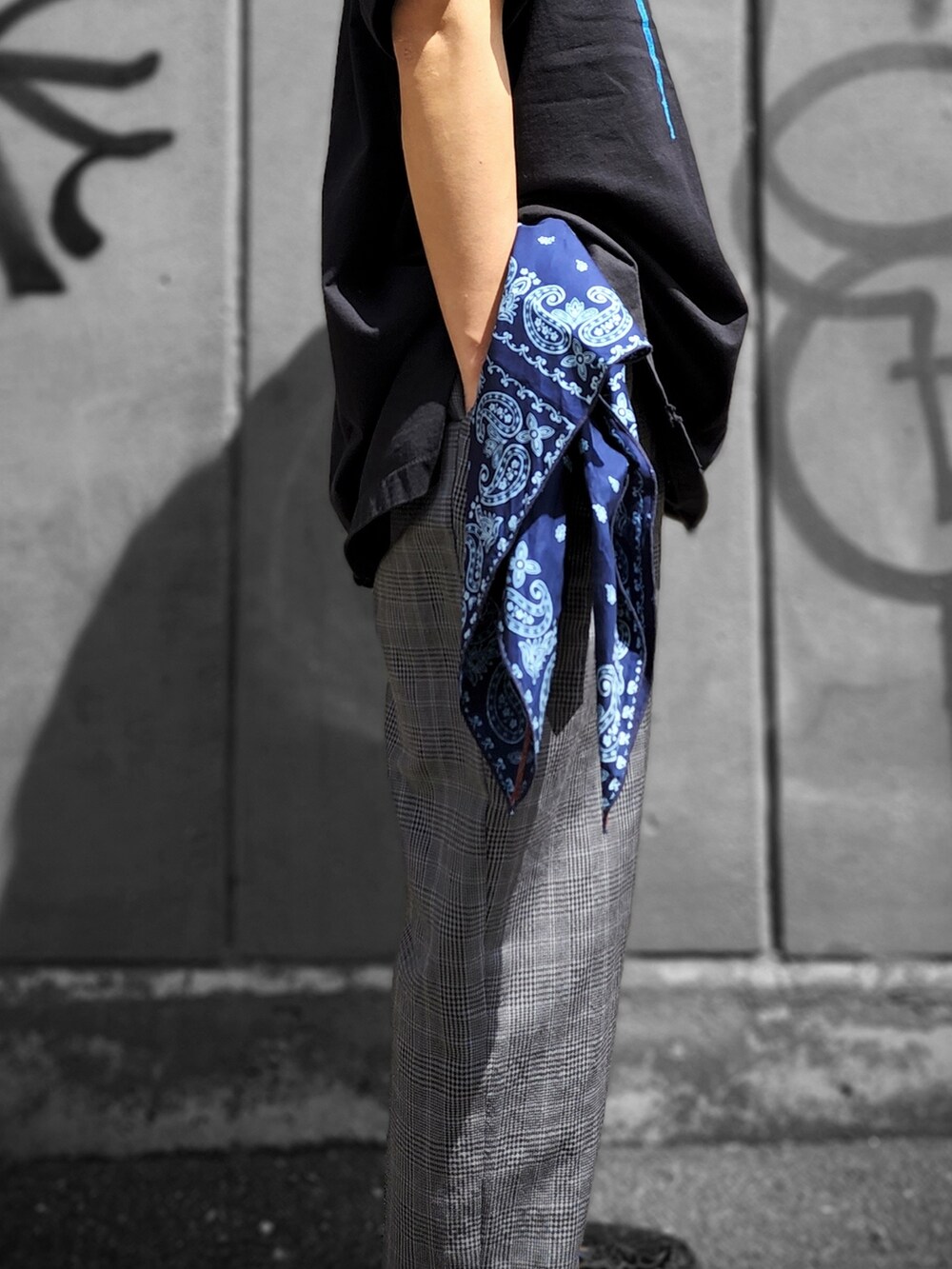 ブラック系のTシャツ/カットソー、グレー系のパンツ、ブルー系のバンダナ/スカーフを着用したメンズの春コーディネートの3枚目の写真