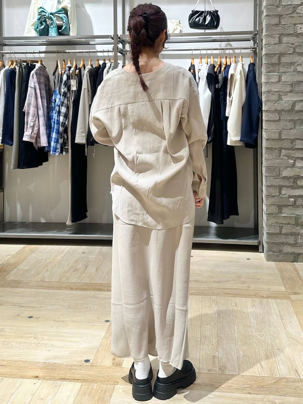 ブラック系のその他シューズ、ブラック系のトートバッグ、ベージュ系のスカートを着用したレディースの春コーディネートの3枚目の写真