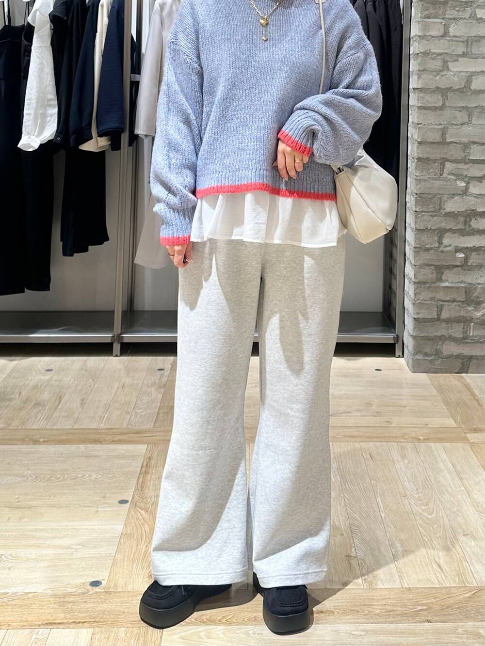 ブラック系のその他アウター、ホワイト系のTシャツ/カットソー、グレー系のショルダーバッグを着用したレディースの冬コーディネートの5枚目の写真