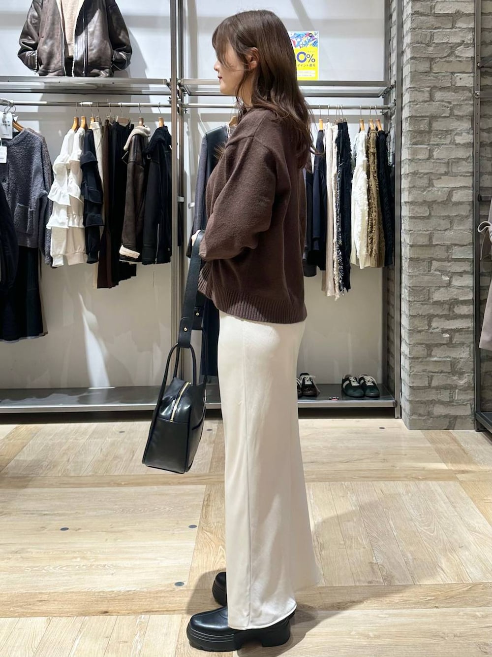 ホワイト系のスカート、ブラウン系のニット/セーター、ブラウン系のその他アウターを着用したレディースの秋コーディネートの6枚目の写真