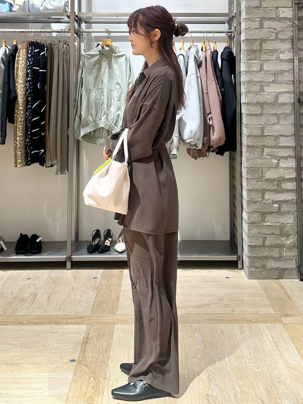 ブラウン系のその他パンツ、ブラウン系のシャツ/ブラウス、ホワイト系のトートバッグを着用したレディースの春コーディネートの2枚目の写真