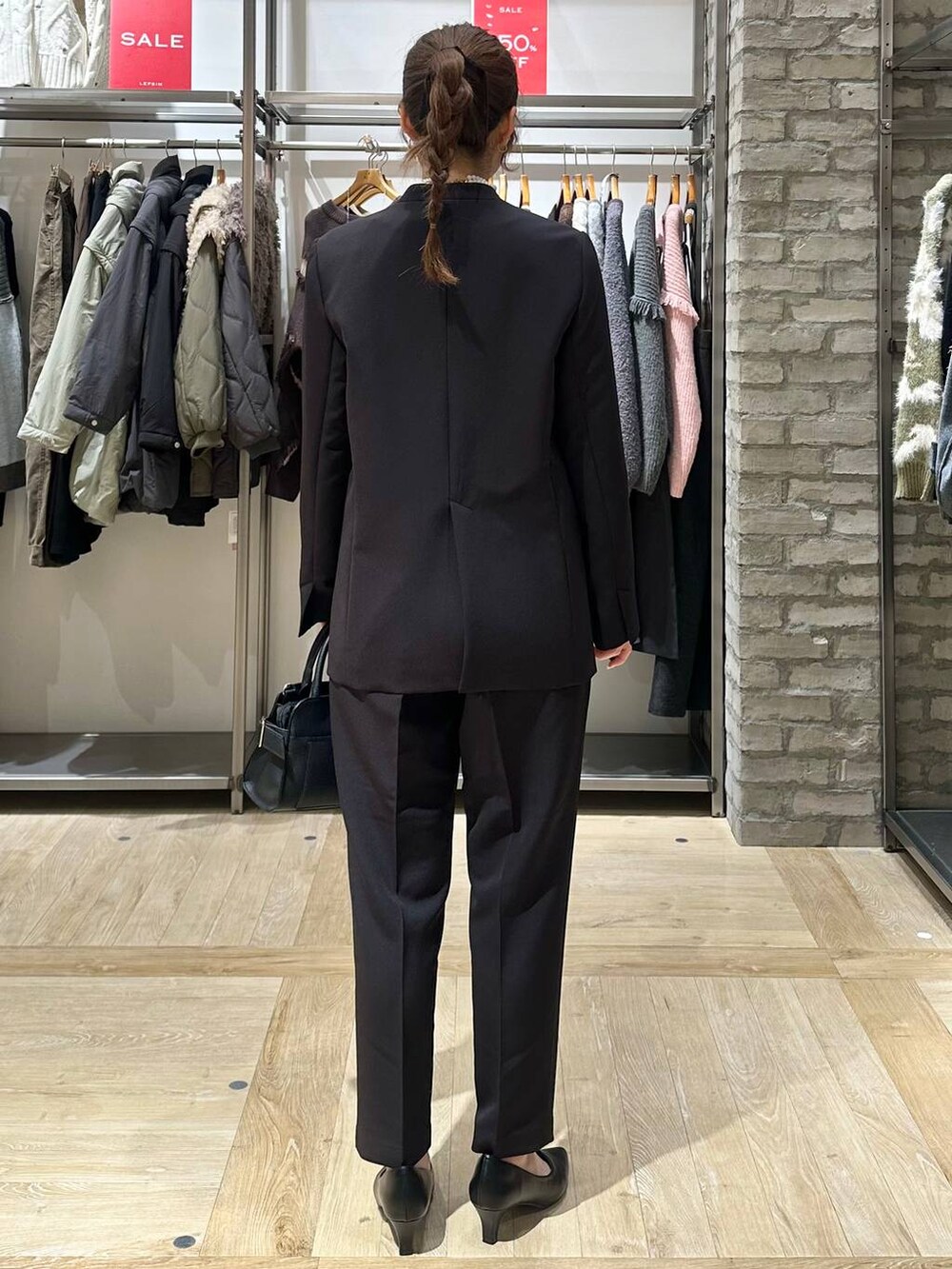 ブラック系のその他パンツ、ブラック系のノーカラージャケット、ブルー系のシャツ/ブラウスを着用したレディースの冬コーディネートの3枚目の写真