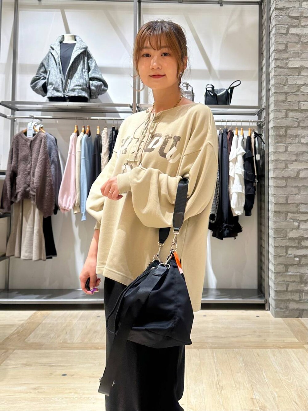 ブラック系のショルダーバッグ、ブラック系のスカート、ホワイト系のその他アウターを着用したレディースの秋コーディネートの7枚目の写真