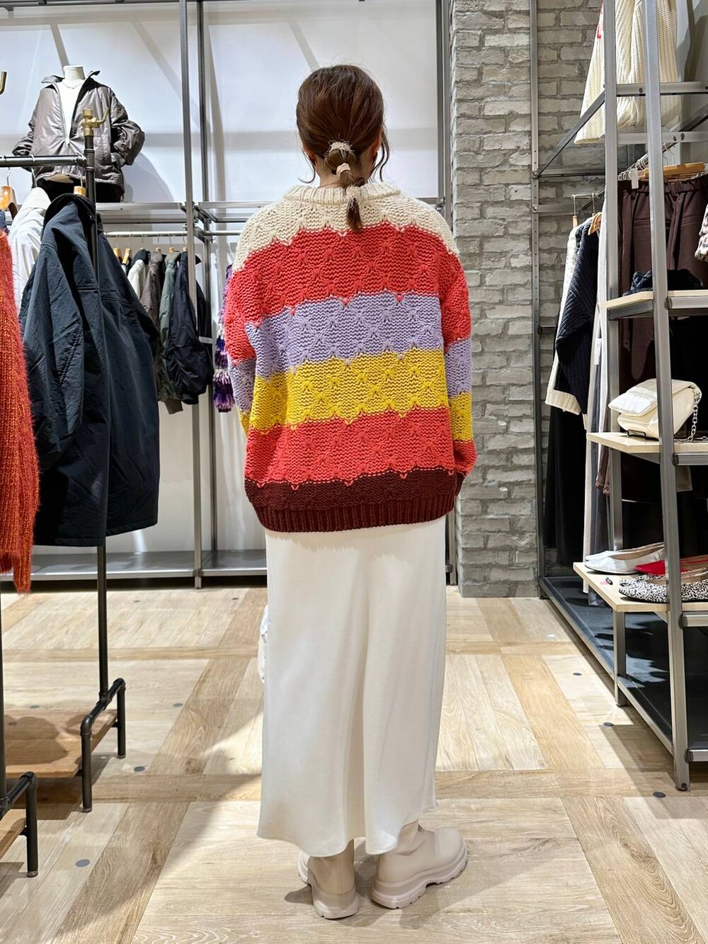 ホワイト系のスカート、ホワイト系のブーツ、ホワイト系のショルダーバッグを着用したレディースの秋コーディネートの4枚目の写真