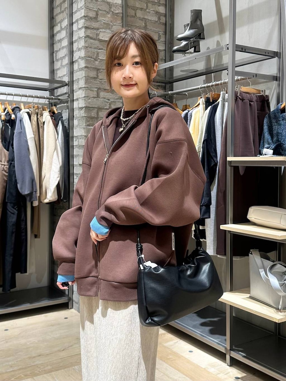 ホワイト系のブーツ、ブラウン系のニット/セーター、ホワイト系のその他アウターを着用したレディースの冬コーディネートの4枚目の写真