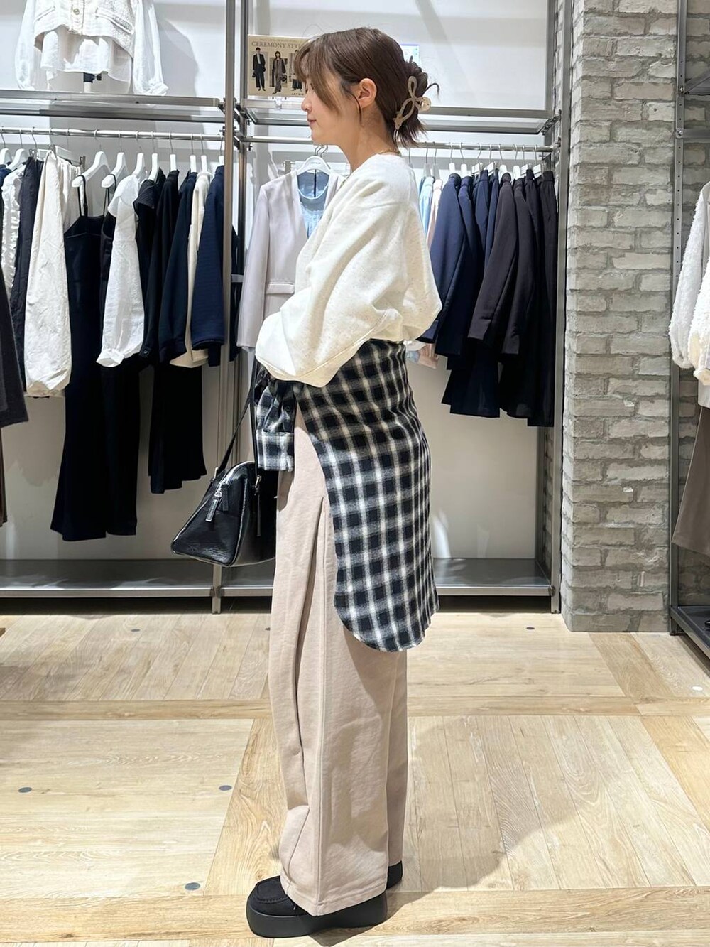 ブラック系のボストンバッグ、ブラック系のその他シューズ、ブラック系のシャツ/ブラウスを着用したレディースの冬コーディネートの2枚目の写真