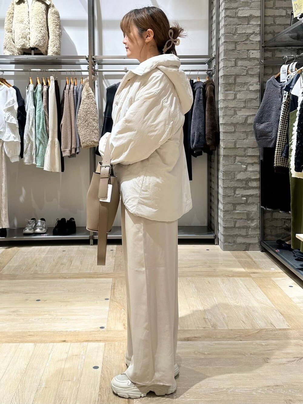 ベージュ系のその他アウター、ホワイト系のその他パンツ、ブラウン系のショルダーバッグを着用したレディースの秋コーディネートの7枚目の写真
