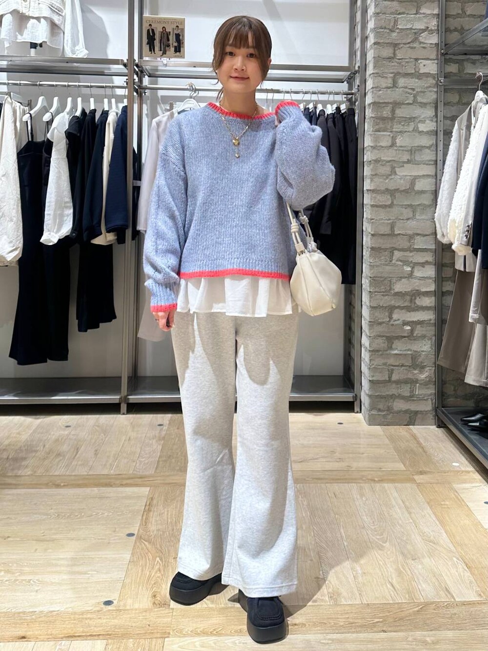 ブラック系のその他アウター、ホワイト系のTシャツ/カットソー、グレー系のショルダーバッグを着用したレディースの冬コーディネートの5枚目の写真