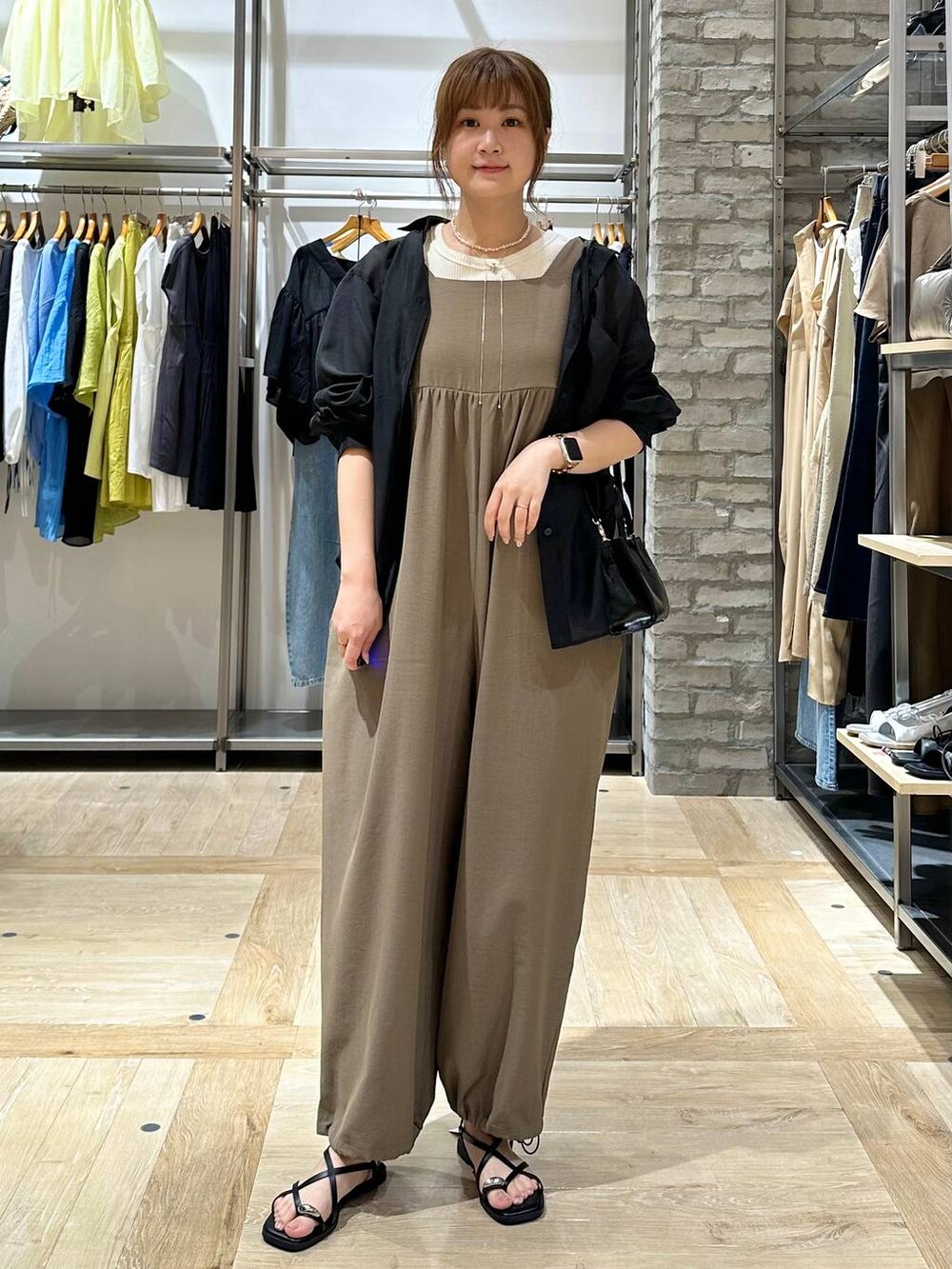 ホワイト系のタンクトップ、イエロー系のつなぎ/オールインワン、ブラック系のサンダルを着用したレディースの夏コーディネートの5枚目の写真