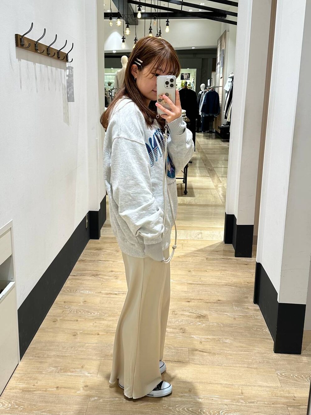 グレー系のTシャツ/カットソー、ホワイト系のスカート、グレー系のスウェットを着用したレディースの冬コーディネートの3枚目の写真