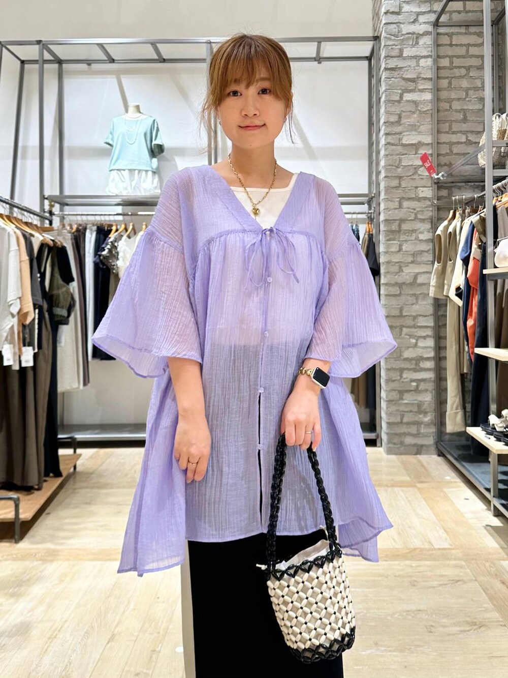 ブラック系のスカート、ホワイト系のタンクトップ、パープル系のチュニックを着用したレディースの夏コーディネートの4枚目の写真