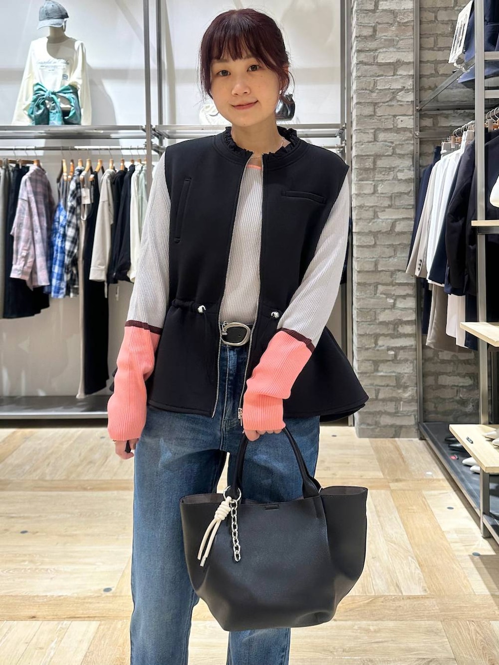 ブラック系のその他シューズ、ブラック系のトートバッグ、ブルー系のデニムパンツを着用したレディースの春コーディネートの4枚目の写真