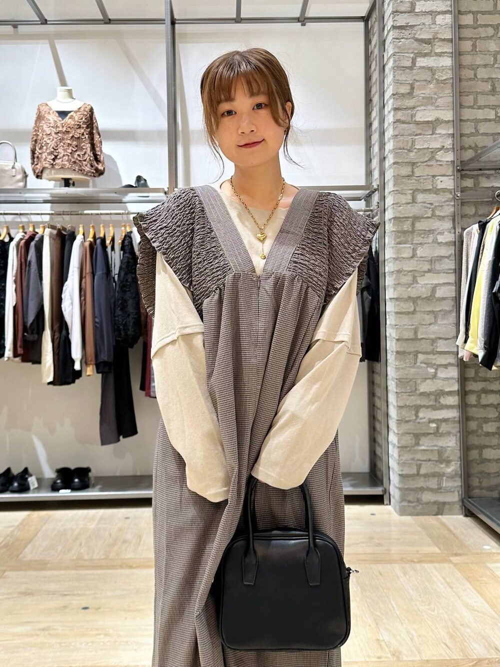 ブラック系のその他パンツ、ブラック系のスニーカー、ベージュ系のTシャツ/カットソーを着用したレディースの秋コーディネートの5枚目の写真