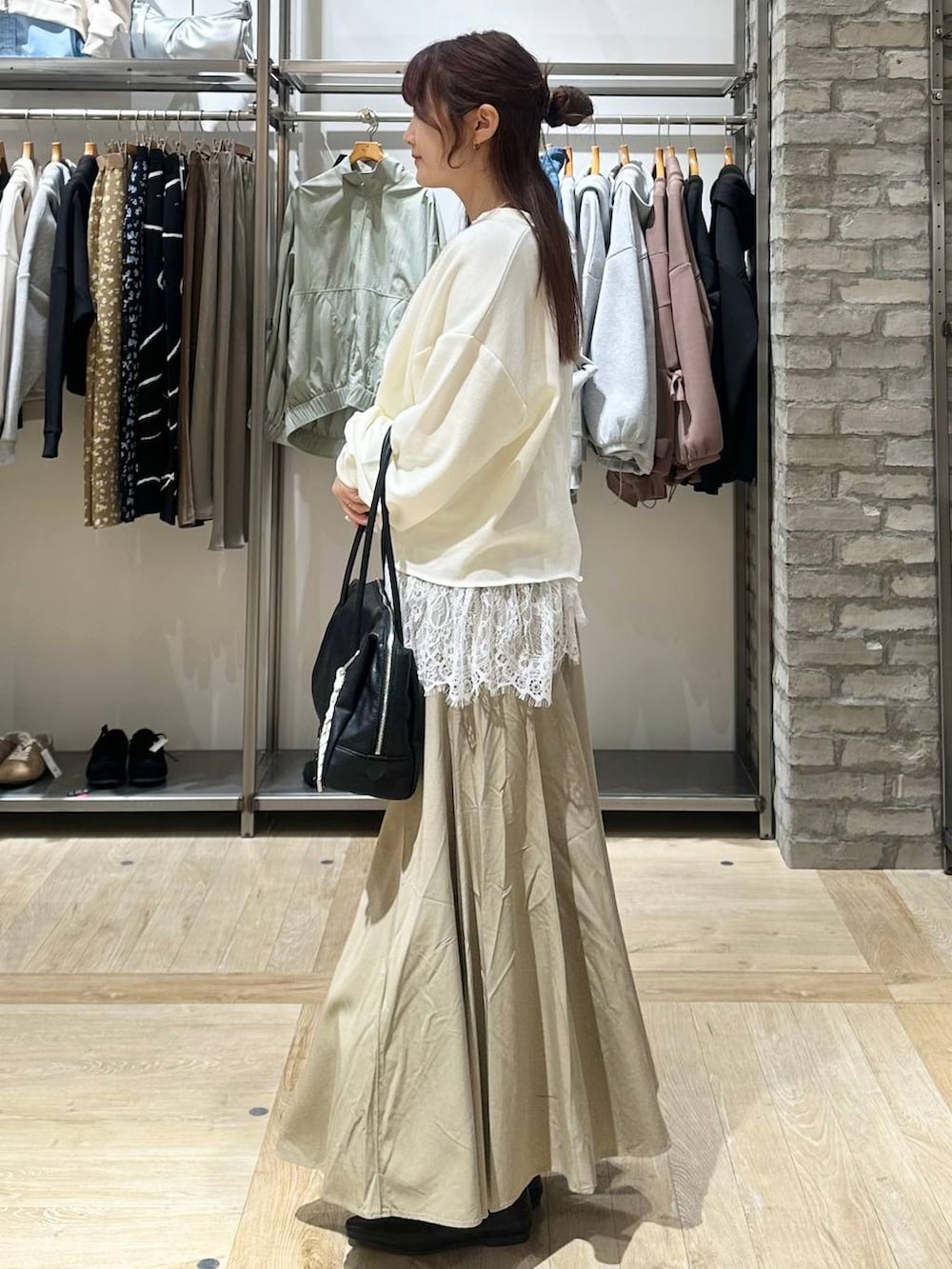 ブラック系のボストンバッグ、ホワイト系のキャミソール、ホワイト系のTシャツ/カットソーを着用したレディースの春コーディネートの2枚目の写真