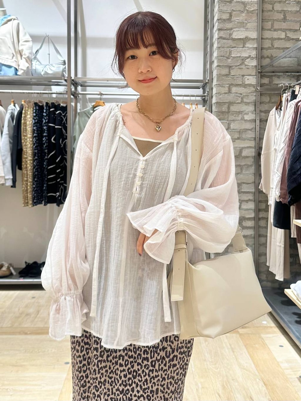 ホワイト系のショルダーバッグ、ホワイト系のパンプス、ホワイト系のシャツ/ブラウスを着用したレディースの春コーディネートの4枚目の写真