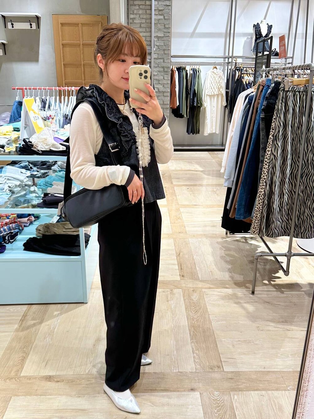 ブラック系のその他パンツ、グレー系のベスト、ホワイト系のTシャツ/カットソーを着用したレディースの春コーディネートの3枚目の写真