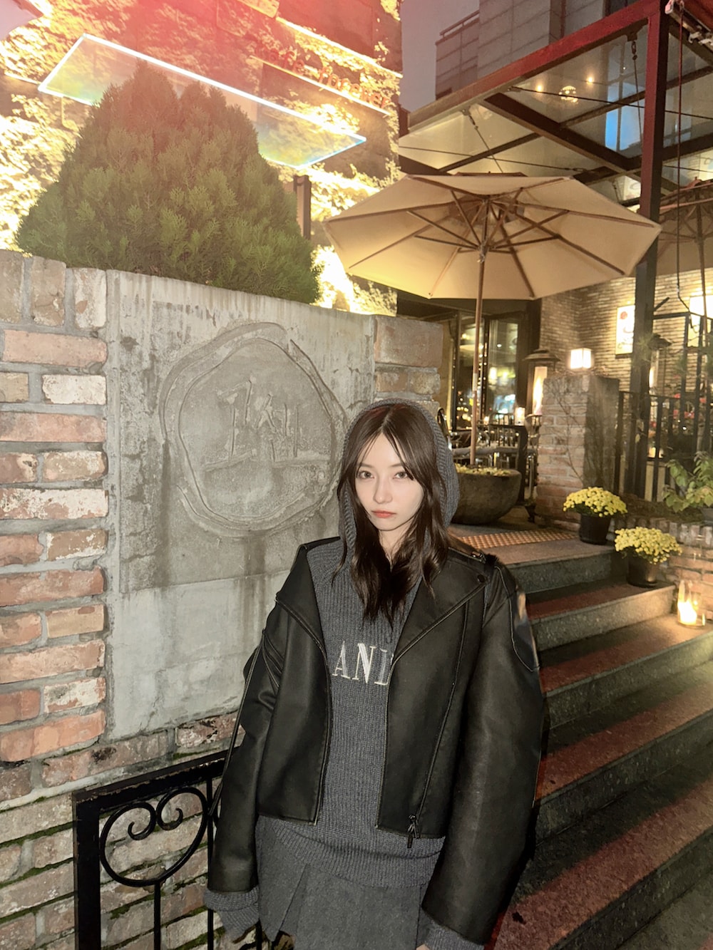 グレー系のパーカー、ブラック系のショルダーバッグを着用したレディースの冬コーディネートの2枚目の写真