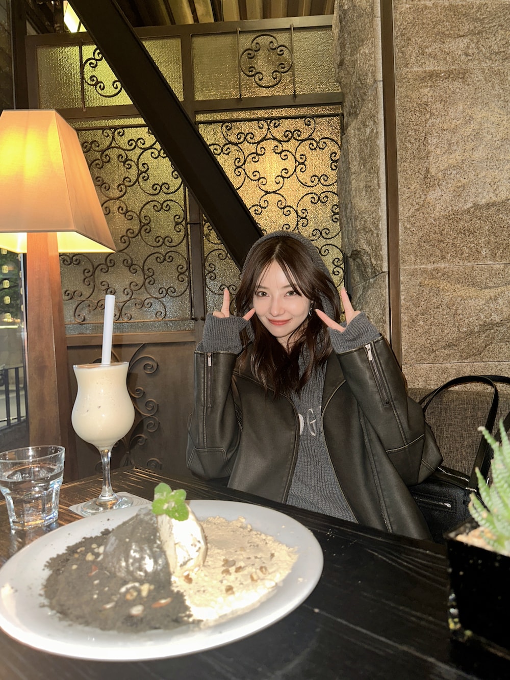 グレー系のパーカー、ブラック系のショルダーバッグを着用したレディースの冬コーディネートの4枚目の写真