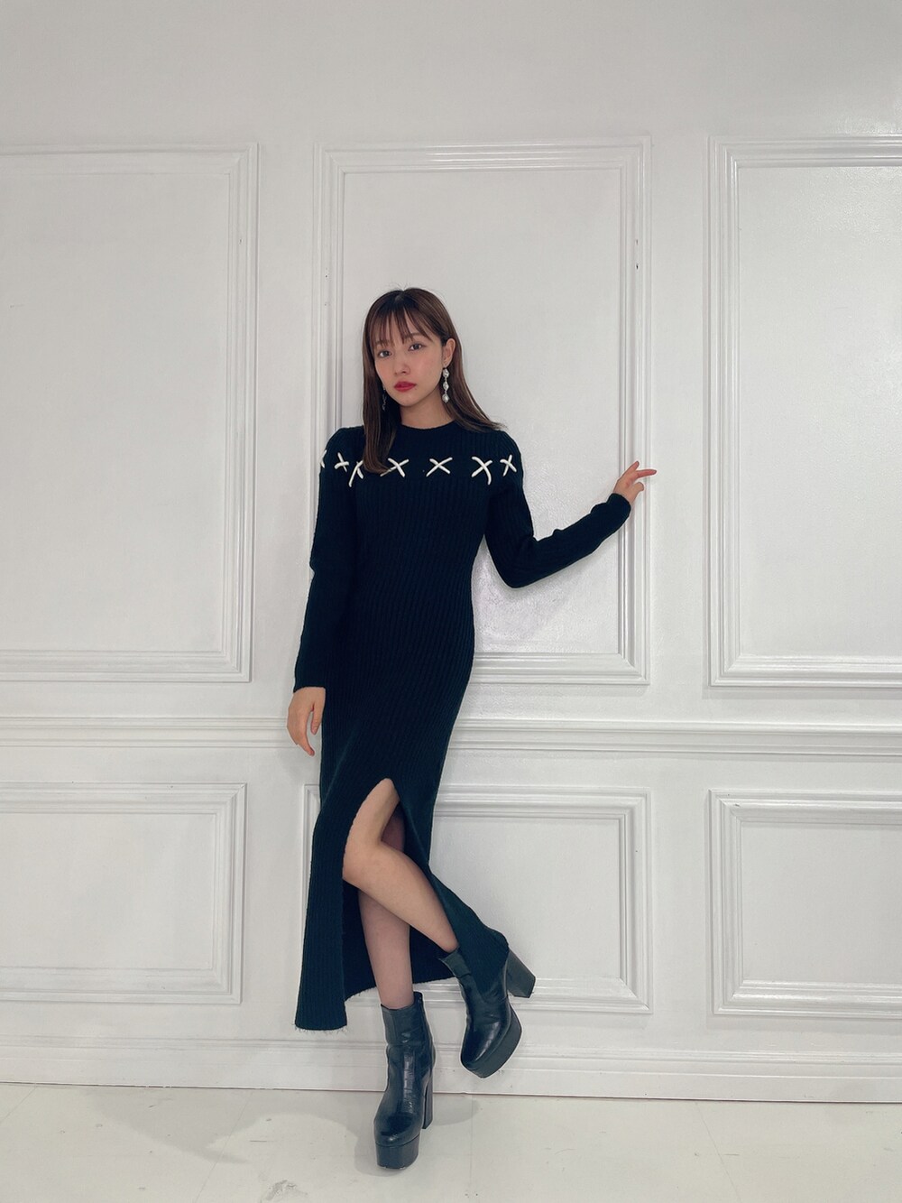 ブラック系のワンピース、ブラック系のブーツを着用したレディースの春コーディネートの3枚目の写真