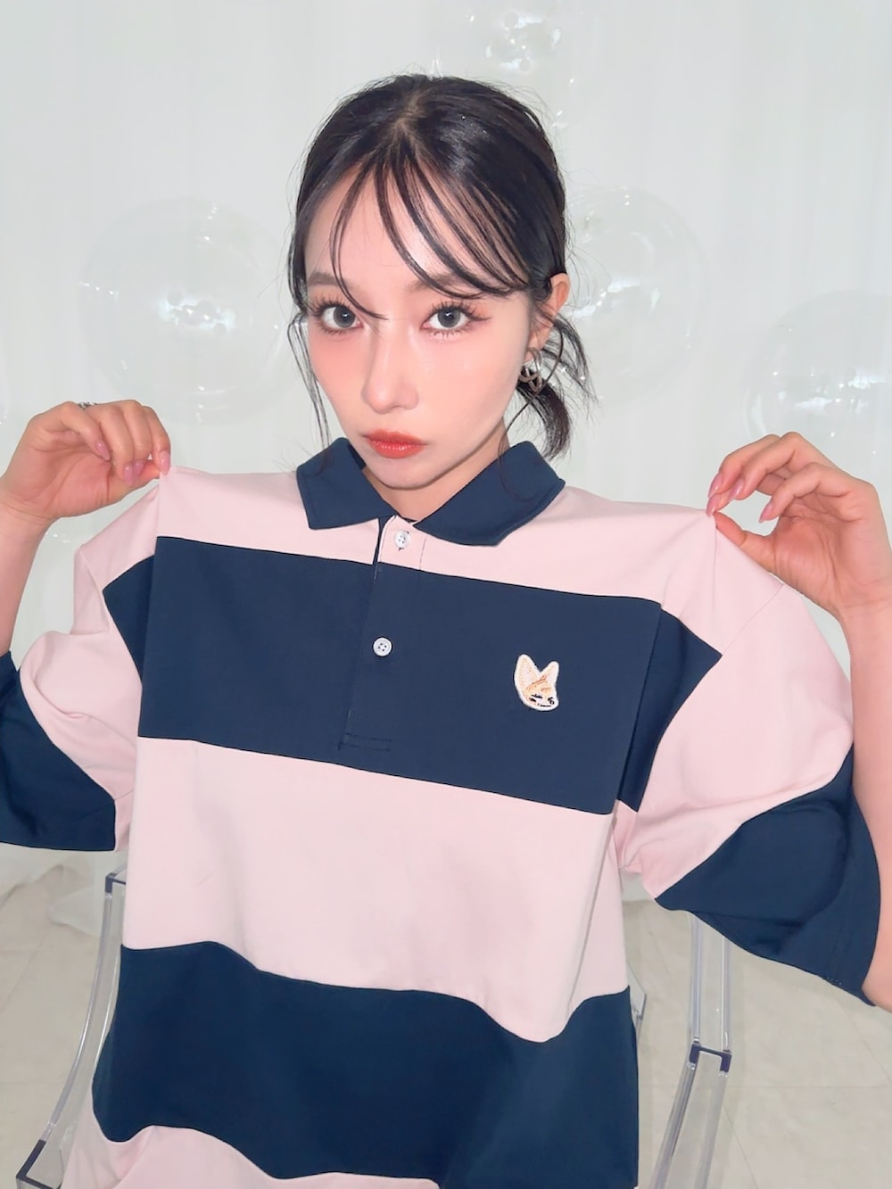 ホワイト系のポロシャツを着用したレディースの夏コーディネートの3枚目の写真