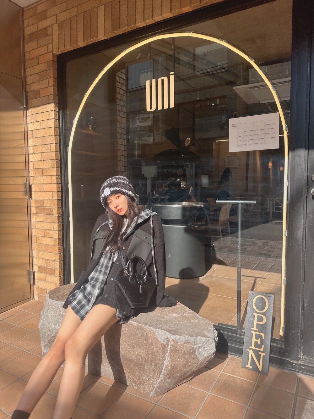 ブラック系のニット/セーター、ブラック系のシャツ/ブラウスを着用したレディースの春コーディネートの3枚目の写真