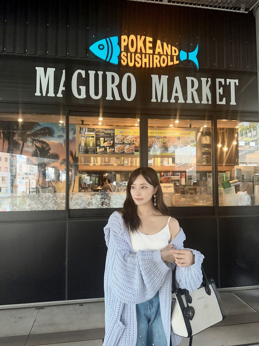 ブルー系のデニムパンツ、ブラック系のショルダーバッグを着用したレディースの冬コーディネートの3枚目の写真