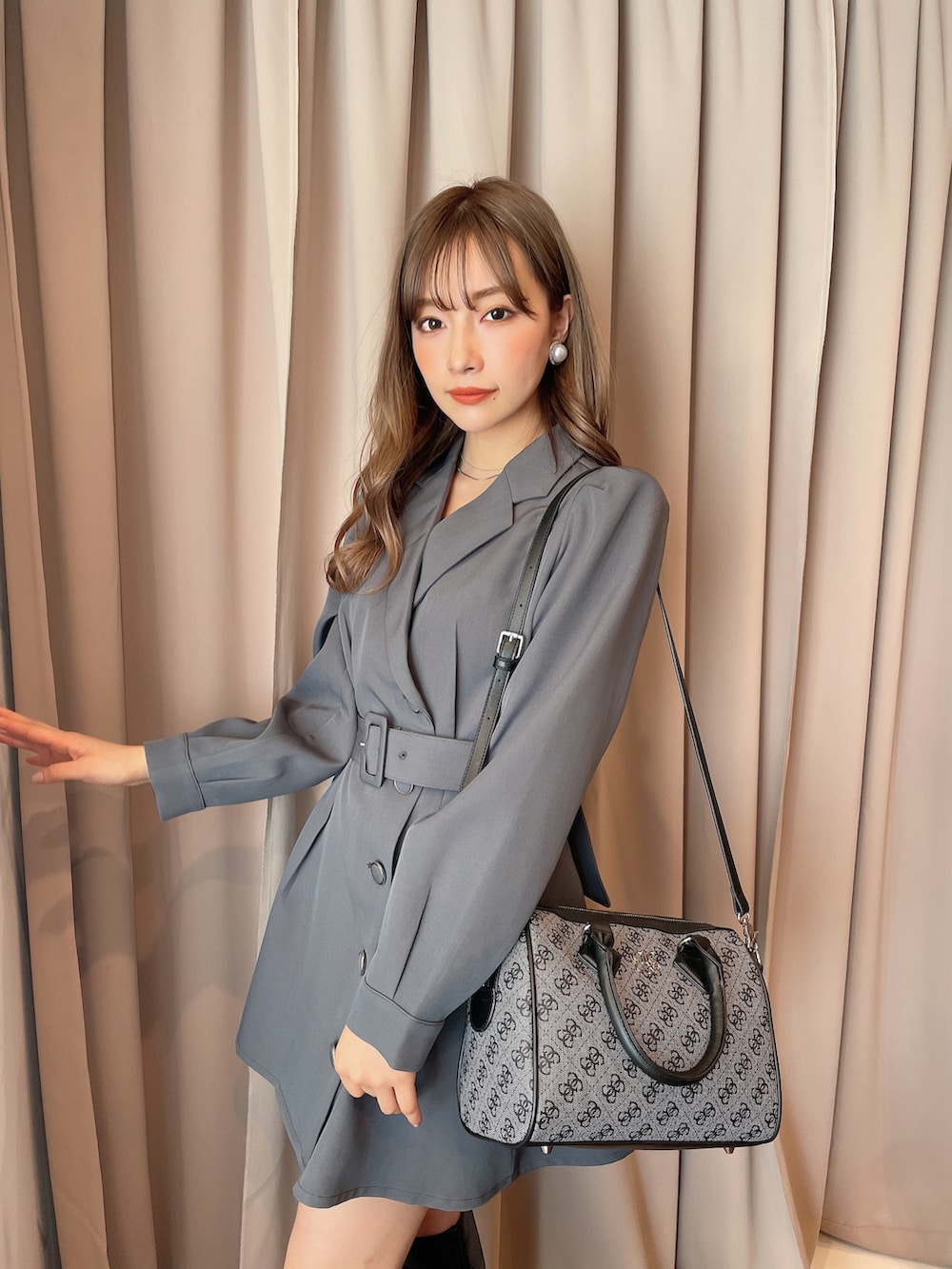 グレー系のワンピース、ブラック系のボストンバッグを着用したレディースの秋コーディネートの3枚目の写真