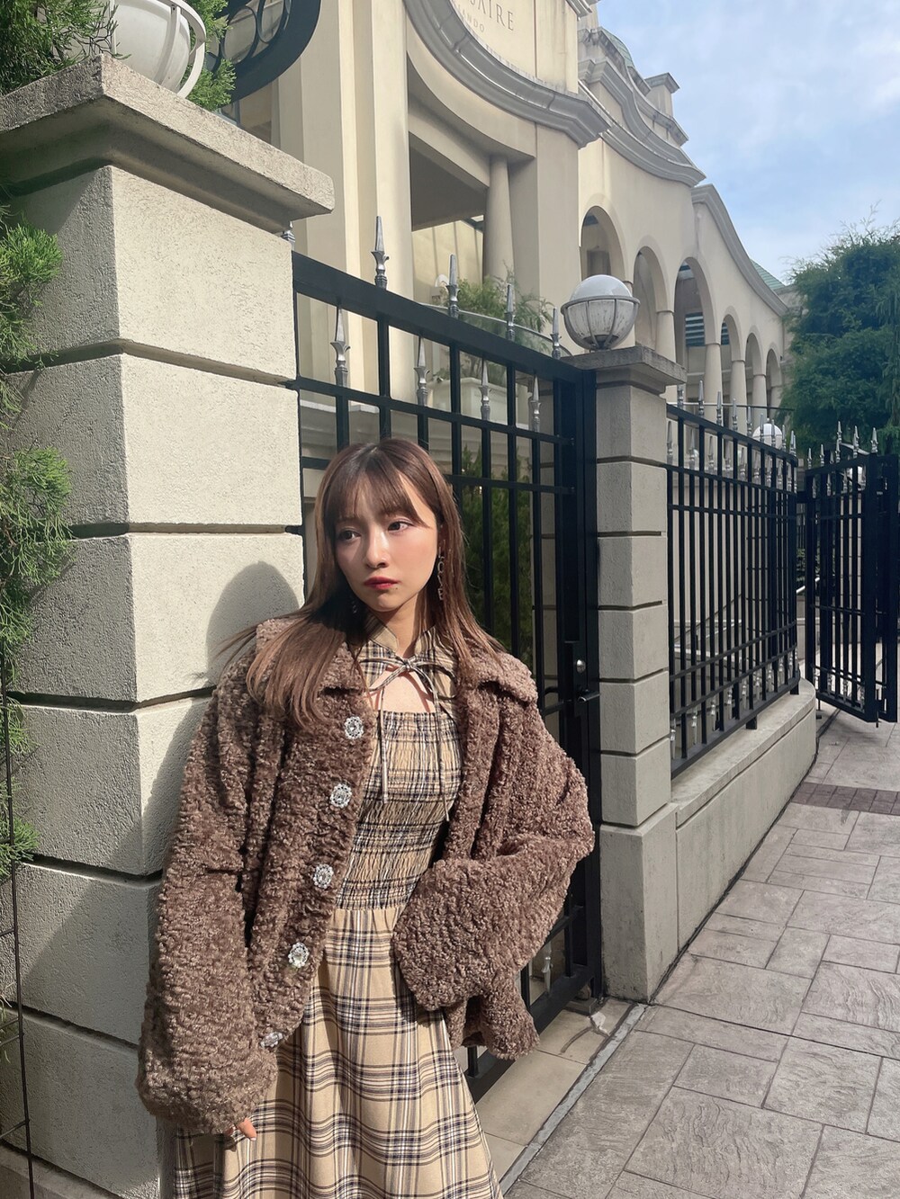 ブラウン系のダウンジャケット/コート、ベージュ系のワンピースを着用したレディースの冬コーディネートの2枚目の写真