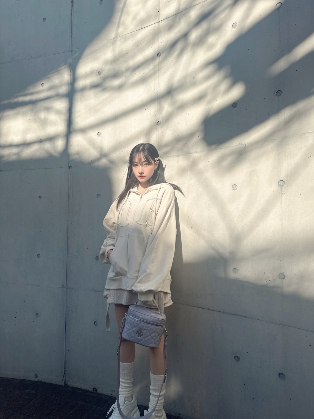 ベージュ系のその他トップス、ホワイト系のパーカー、パープル系のショルダーバッグを着用したレディースの夏コーディネートの2枚目の写真