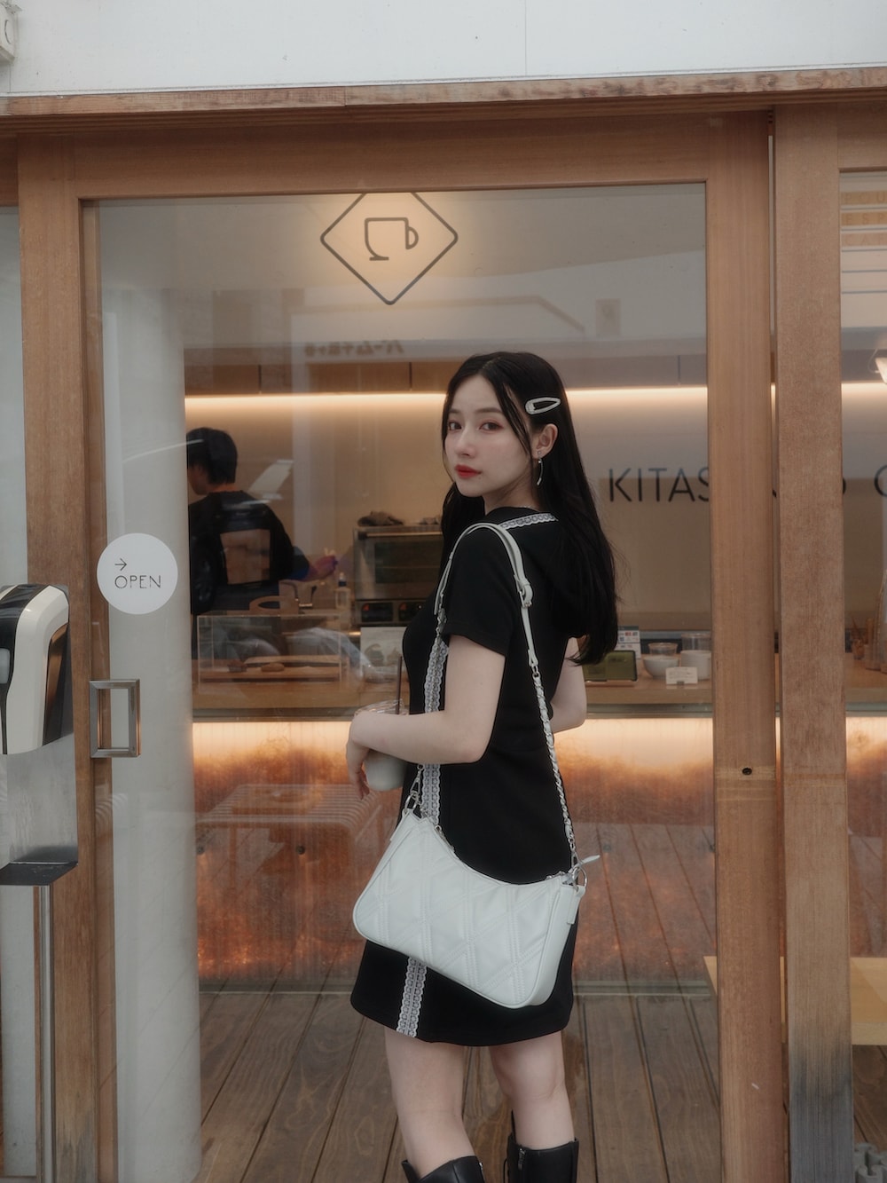 ブラック系のショルダーバッグ、ブラック系のワンピースを着用したレディースの秋コーディネートの2枚目の写真