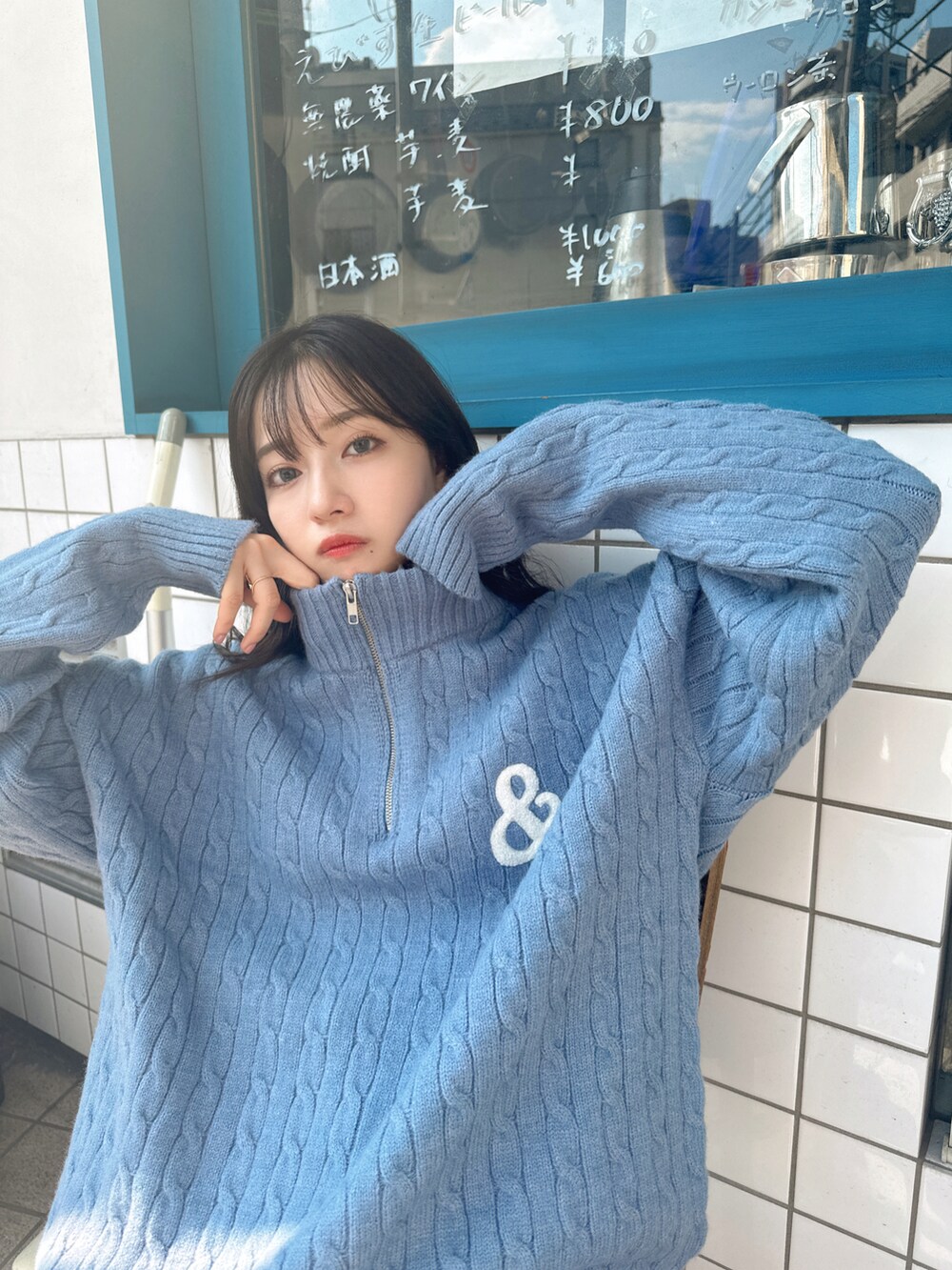 ブルー系のニット/セーターを着用したレディースの秋コーディネートの2枚目の写真