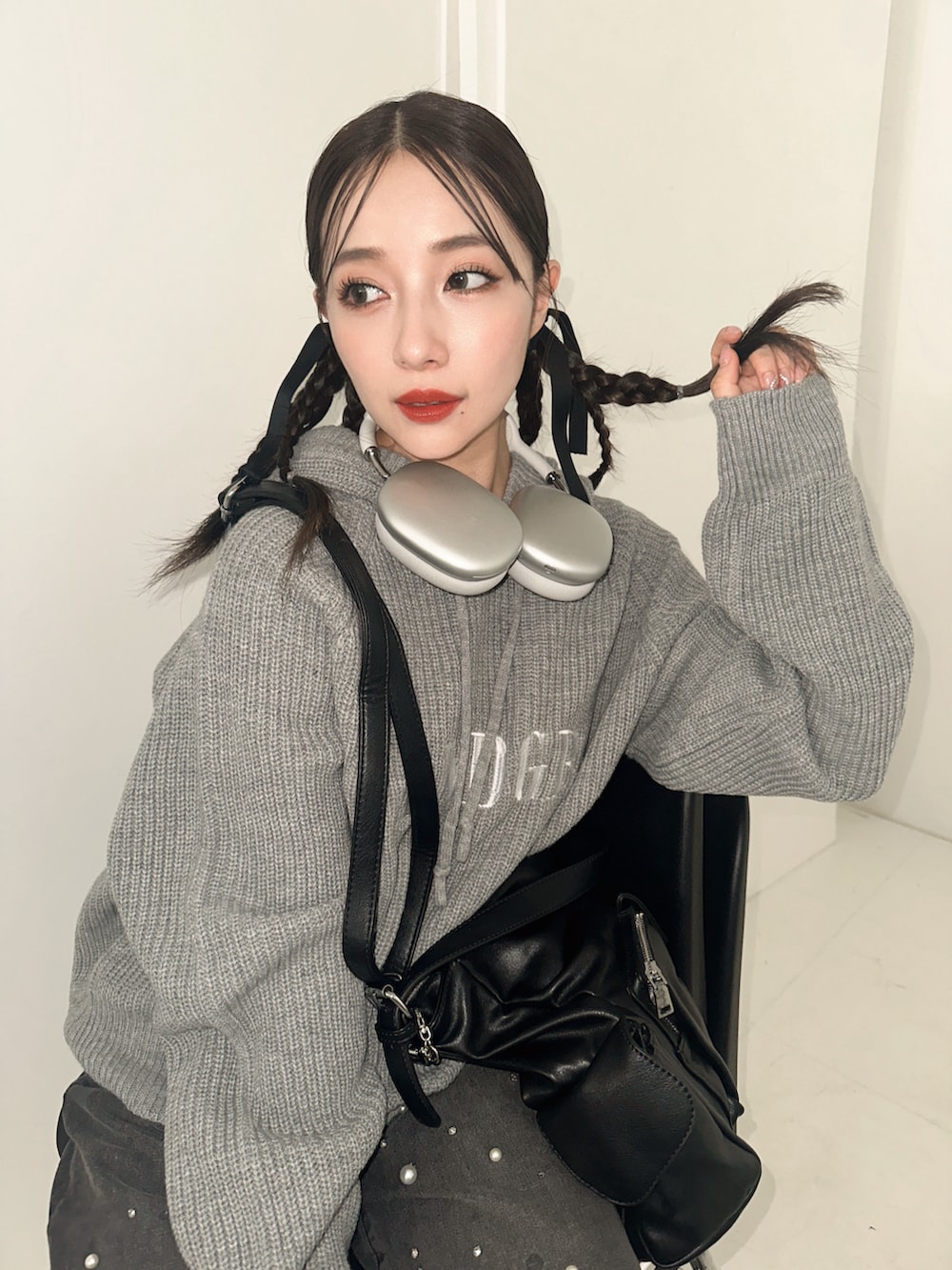 グレー系のパーカー、ブルー系のデニムパンツを着用したレディースの冬コーディネートの3枚目の写真