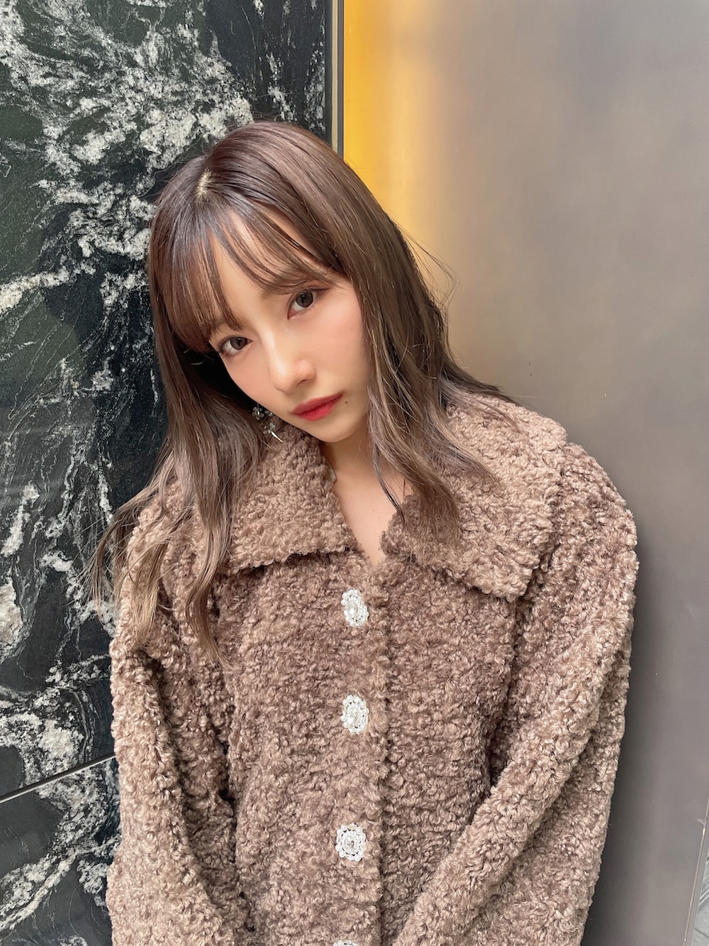 ブラウン系のダウンジャケット/コート、ブラック系のワンピースを着用したレディースの冬コーディネートの5枚目の写真