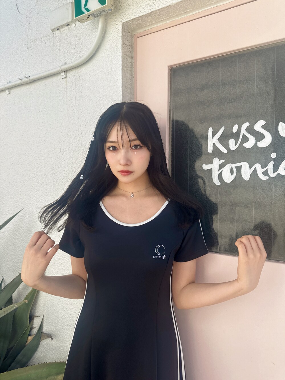 ブラック系のワンピースを着用したレディースの春コーディネートの2枚目の写真