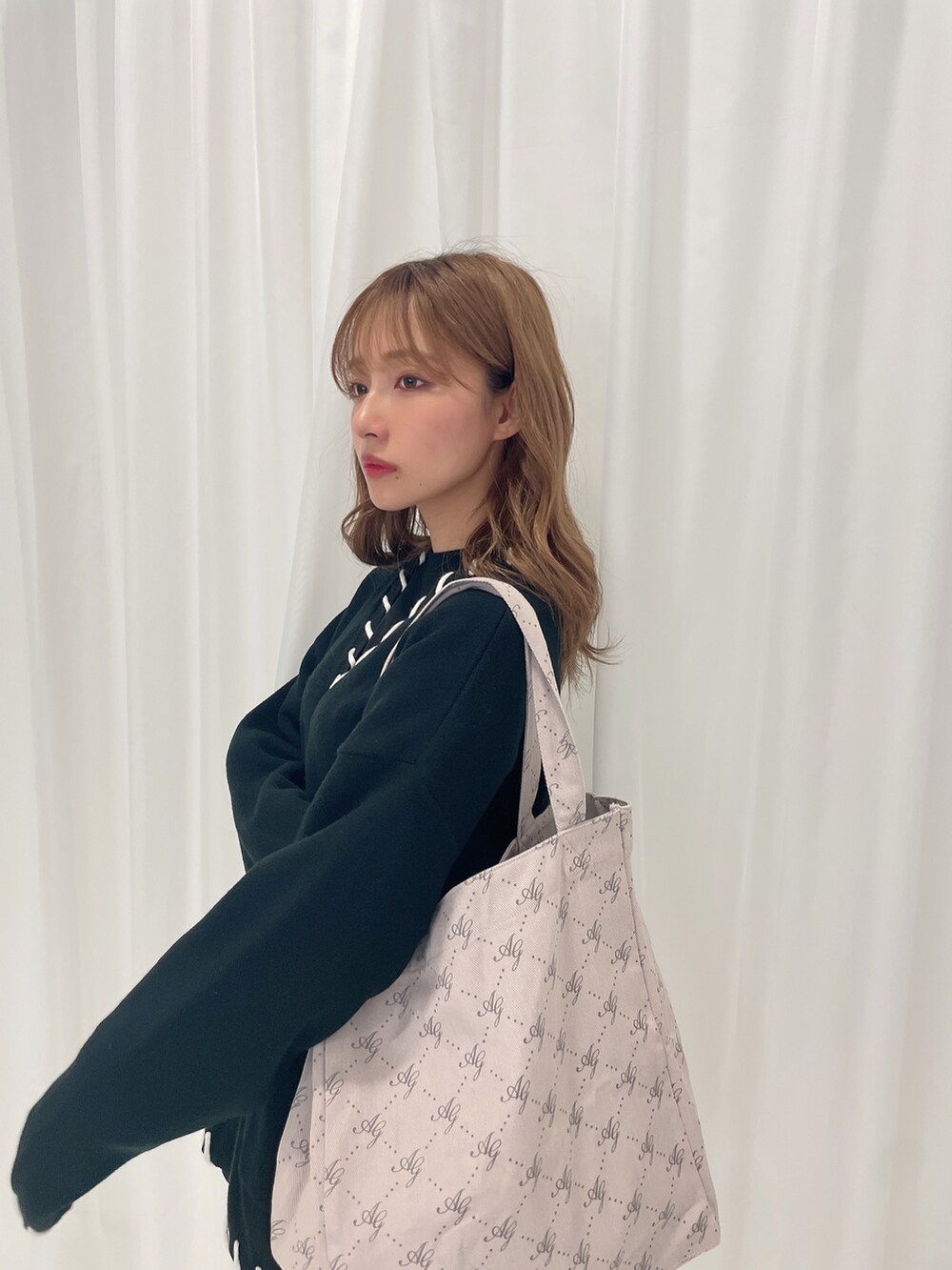 ブラック系のカーディガン/ボレロ、グレー系のトートバッグを着用したレディースの秋コーディネートの4枚目の写真